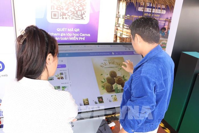 Tiểu thương tìm hiểu cách tạo clip và poster quảng bá sản phẩm lên sàn thương mại điện tử. Ảnh: Hồng Nhung - TTXVN