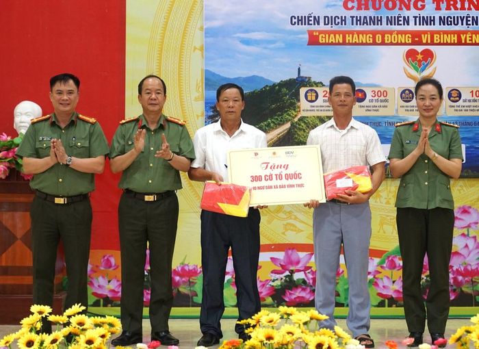 Các đồng chí lãnh đạo Công an tỉnh Quảng Ninh trao tặng 300 lá cờ Tổ quốc cho xã Vĩnh Thực.
