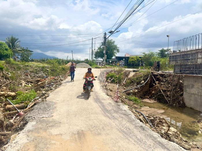 Người dân đang lưu thông qua suối Thị bằng đập tạm