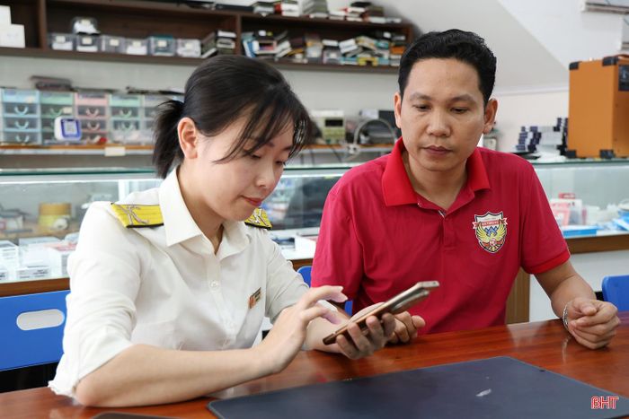 Cán bộ Thuế tỉnh Hà Tĩnh hỗ trợ hộ kinh doanh cài đặt và sử dụng ứng dụng eTax Mobile.