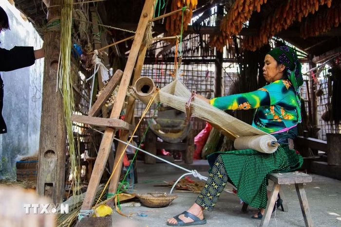 Bên chiếc guồng quay sợi, những bàn tay cần mẫn vẫn miệt mài với nghề truyền thống, bất chấp sự thay đổi của đời sống hiện đại. (Ảnh: Lan Anh/TTXVN phát)