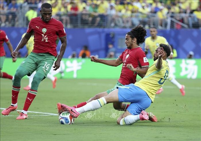 Tiền đạo Matheus Cunha (phải) của Brazil tranh bóng với Ayyoub Bouaddi (giữa) của tuyển Morocco. Ảnh: THX/TTXVN