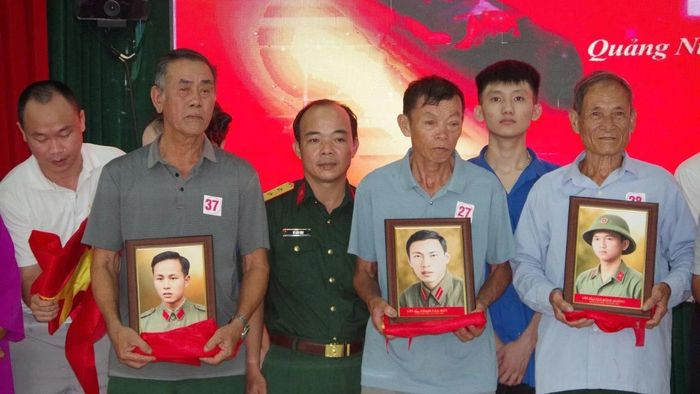 Thân nhân các liệt sĩ xúc động đón nhận những bức di ảnh được phục dựng từ các tấm ảnh cũ đã phai mờ theo thời gian.