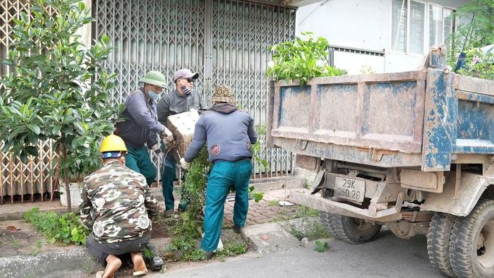 Các lực lượng chức năng xã Hoài Đức tháo dỡ, di dời các công trình, vật dụng lấn chiếm vỉa hè. Ảnh: HĐ
