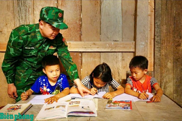 Cán bộ Đồn Biên phòng Cốc Pàng hướng dẫn các cháu là “con nuôi” của đơn vị học tập. Ảnh: Hoàng Trang
