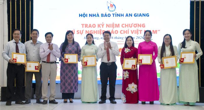 Trao Kỷ niệm chương “Vì sự nghiệp báo chí Việt Nam” cho hội viên. Ảnh: TRƯƠNG MINH ĐIỀN