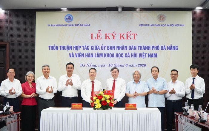 Chủ tịch Viện Hàn lâm Khoa học xã hội Việt Nam Lê Văn Lợi (thứ 5, phải sang) và Chủ tịch UBND thành phố Đà Nẵng Nguyễn Mạnh Hùng (thứ 5, trái sang) ký kết Biên bản thỏa thuận hợp tác. Ảnh: VINH ANH
