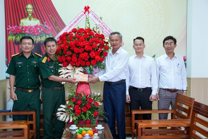 Đoàn công tác tặng hoa, quà chúc mừng Ban đại diện Báo Quân đội nhân dân tại miền Trung - Tây Nguyên. Ảnh: T.CÔNG