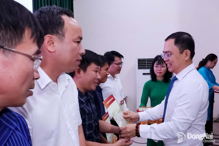 Phó Bí thư Đảng ủy, Chủ tịch UBND phường Long Thành Lê Hoàng Sơn tặng quà chúc mừng các nhà báo. Ảnh: Nguyệt Hà