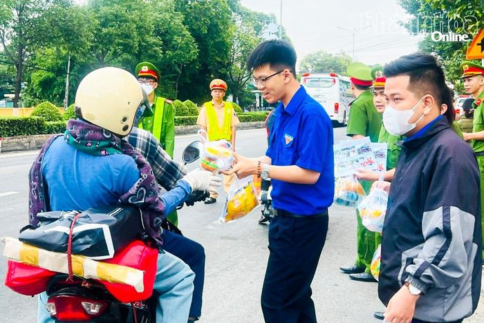 Thanh niên phường Cam Ranh phối hợp phát nước uống, bánh miễn phí cho người dân về quê ăn Tết.