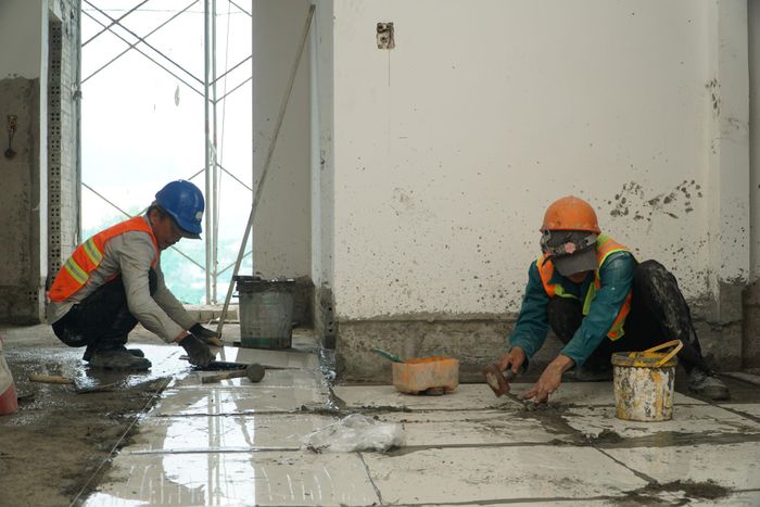 Công nhân thi công phần ốp lát bên trong chung cư