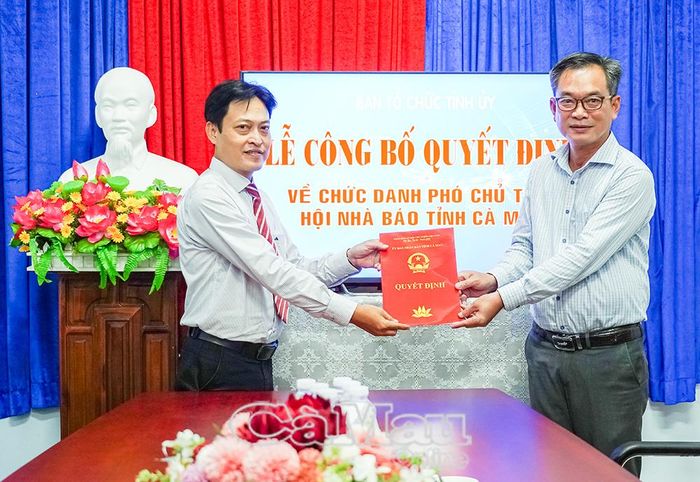 Đồng chí Nguyễn Văn Khởi, Phó Chủ tịch Ủy ban MTTQ Việt Nam tỉnh Cà Mau (bên phải), trao Quyết định chuyển công tác cho đồng chí Lê Kiên Giang.