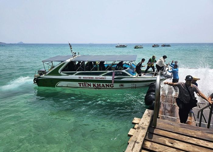 Du khách đi ca nô đến điểm du lịch nổi tiếng ở Kỳ Co để check-in