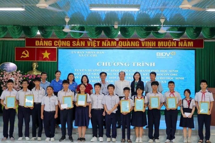 Lãnh đạo xã Củ Chi, đại diện đơn vị tài trợ và Ban Giám hiệu Trường THCS Tân Phú Trung chụp ảnh lưu niệm cùng các học sinh đạt thành tích xuất sắc tại kỳ thi học sinh giỏi cấp Thành phố.