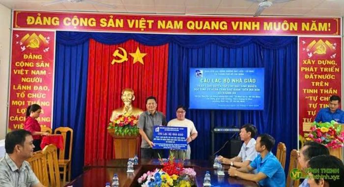 Ông Ngô Thanh Phong (bên trái) – Chủ tịch Ủy ban MTTQ Việt Nam xã Khánh An tiếp nhận bảng tượng trưng 1.000 quyển tập từ Ban Liên lạc Đồng hương Bạc Liêu - Cà Mau tại TP.HCM để trao cho học sinh có hoàn cảnh khó khăn trên địa bàn.