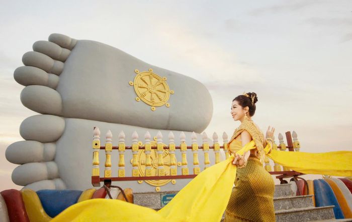 Du khách chụp ảnh tại bàn chân Phật trong chùa Som Rong, phường Sóc Trăng, TP Cần Thơ.
