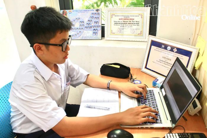 Em Nguyễn Vũ Tiến Đoàn bên góc học tập của mình.