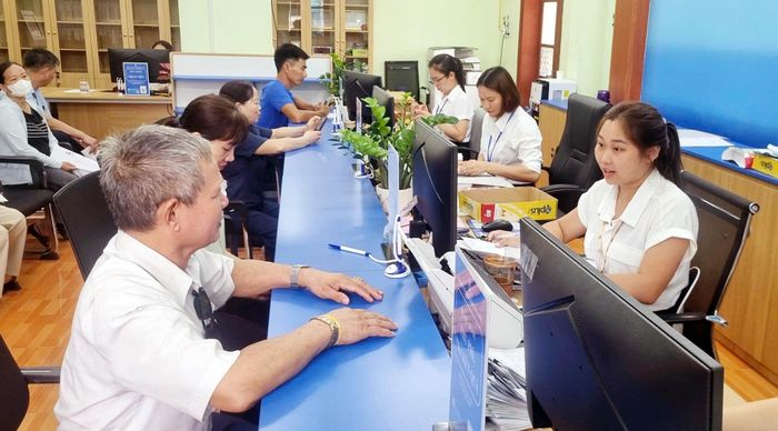 Nhân viên Trung tâm Phục vụ hành chính công xã Đa Phúc tiếp nhận giải quyết hồ sơ cho người dân. Ảnh: Hồng Kỳ