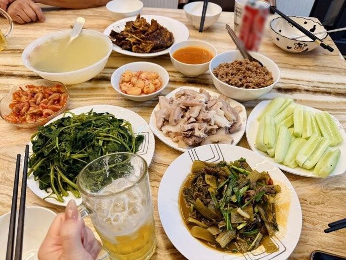 Trong mâm cơm chúc mừng con gái, những món ăn quen thuộc của mùa hè Bắc Bộ hiện diện đầy đủ. Đĩa thịt luộc được thái gọn gàng, ăn kèm dưa chuột chẻ thanh mát. Bát thịt băm đậm đà giúp bữa ăn thêm tròn vị. Nổi bật nhất là đĩa rau muống luộc xanh mướt cùng bát nước canh đánh chua giải nhiệt - những món ăn được xem là "linh hồn" của bữa cơm mùa hè của nhiều gia đình Việt. Đĩa cà pháo muối giòn tan đặt bên cạnh càng khiến mâm cơm trở nên hấp dẫn và đưa cơm hơn.