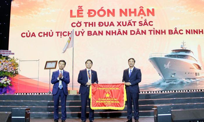 Chủ tịch HĐND tỉnh Nguyễn Việt Oanh trao Cờ thi đua của UBND tỉnh cho lãnh đạo Hội.
