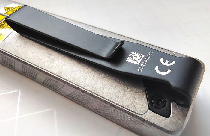 The Olight ArkPro Stars & Stripes flashlight comes with a strong metal clip.