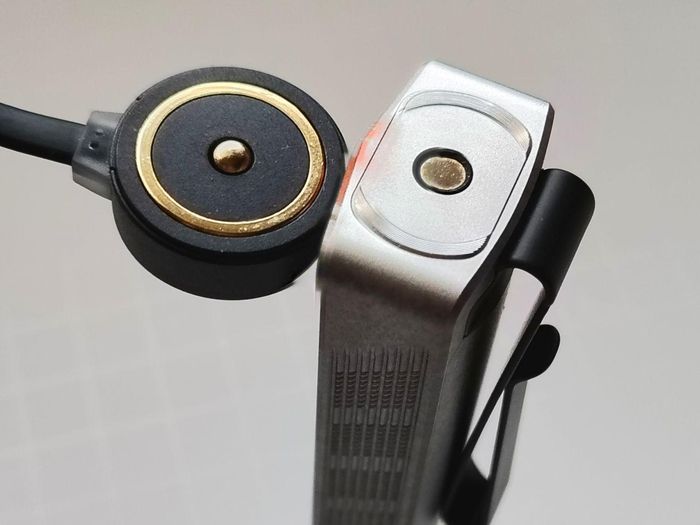 The Olight ArkPro Stars & Stripes flashlight can be recharged with the included magnetic charging pad.