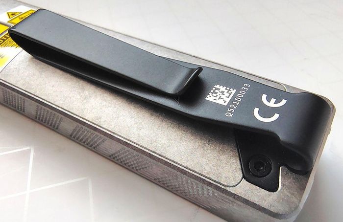 The Olight ArkPro Stars & Stripes flashlight comes with a strong metal clip.