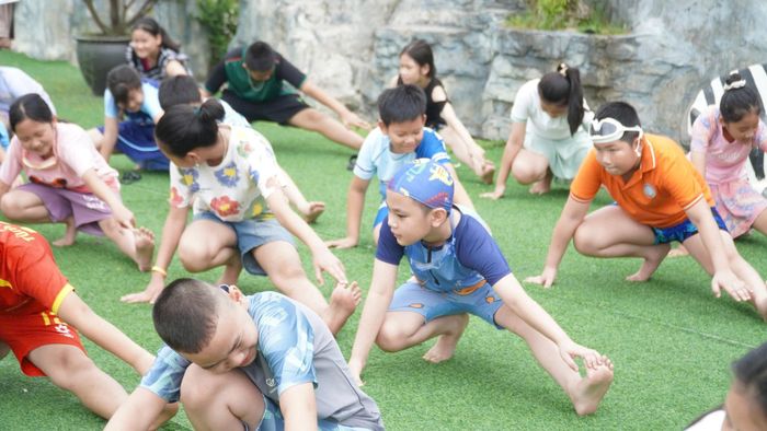 Các em được khởi động trước khi xuống hồ bơi. Ảnh: MK