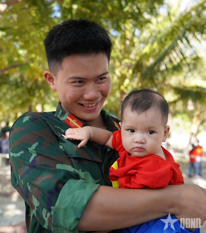 Người lính trẻ và thế hệ tương lai trên điểm đảo. Ảnh: ANH TUẤN