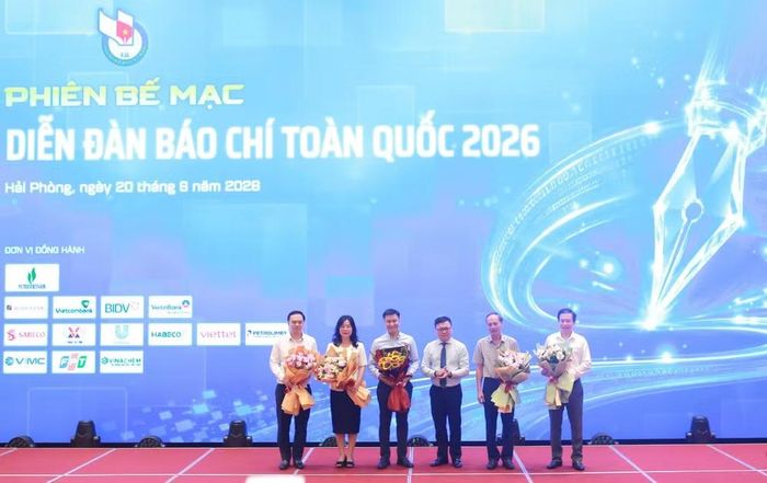 Chủ tịch Hội Nhà báo Việt Nam tặng hoa cảm ơn các diễn giả đã tham gia các phiên thảo luận tại Diễn đàn Báo chí toàn quốc 2026.