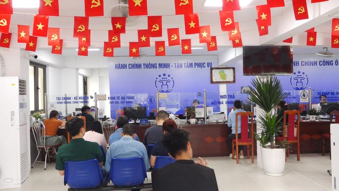 Người dân thực hiện thủ tục hành chính tại Trung tâm Phục vụ hành chính công xã Ô Diên. Ảnh: PV