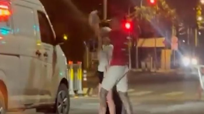 Nam thanh niên dùng nón bảo hiểm đập phá chiếc xe. Ảnh: H.TÂM