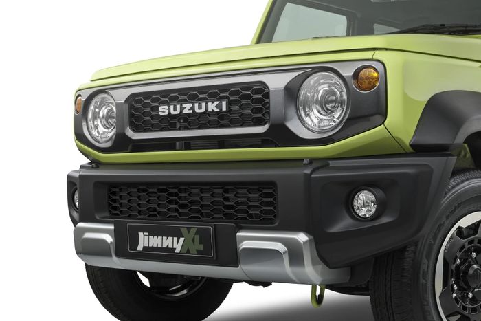  Phần đầu xe Suzuki Jimny Rhino Special Edition nổi bật với thiết kế lưới tản nhiệt Suzuki Heritage di sản của thương hiệu, đi kèm ốp trang trí cản trước màu bạc satin. 