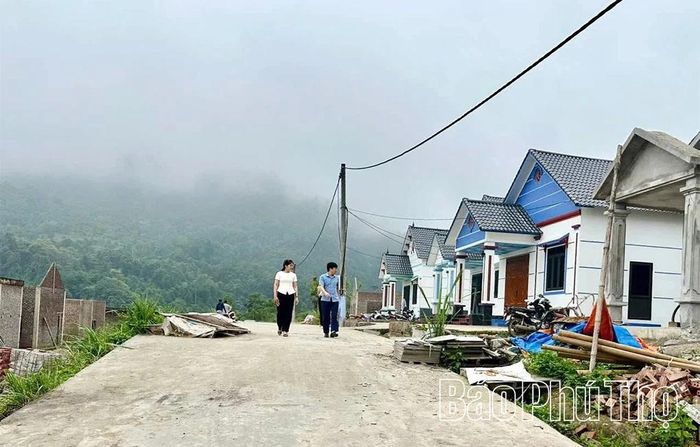 Cán bộ xã Lai Đồng kiểm tra tiến độ xây dựng nhà ở của các hộ dân chuyển ra khu tái định cư Bản Lài.