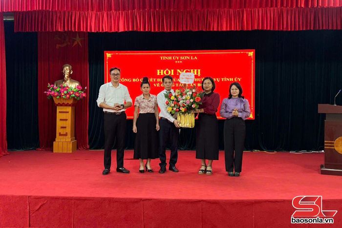 Đại diện lãnh đạo xã Mường Bú tặng hoa chúc mừng ông Lù Văn Quí.