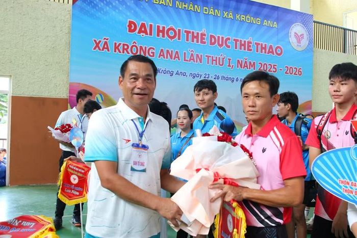 Ông Hoàng Minh Giám tặng hoa, cờ lưu niệm cho các đoàn vận động viên. (Ảnh: TH).