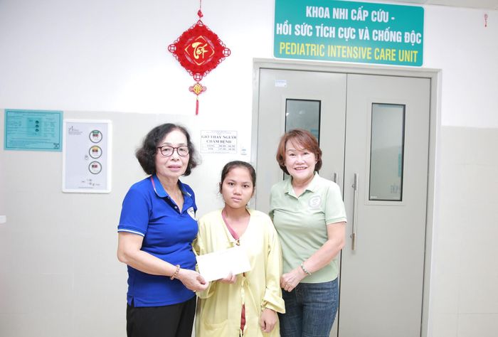 Đại diện Hội Từ thiện và Bảo vệ quyền trẻ em thành phố Đà Nẵng trao quà cho một trong 2 trường hợp bệnh nhi có hoàn cảnh đặc biệt khó khăn. Ảnh: ĐẮC MẠNH