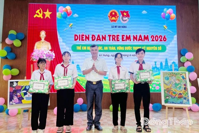 Đại diện lãnh đạo UBND xã Mỹ An Hưng trao giải cho các em đạt giải cuộc thi vẽ tranh tại diễn đàn. 