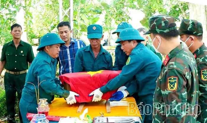 Lực lượng dân quân xã Thanh Ba hỗ trợ khai quật, lấy mẫu hài cốt liệt sĩ.