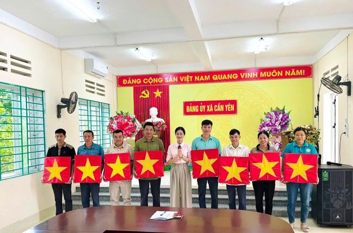 Chị Tô Phương Chi, Bí thư Đảng ủy, Chủ tịch HĐND xã Cần Yên trao tặng cờ cho các hộ gia đình.
