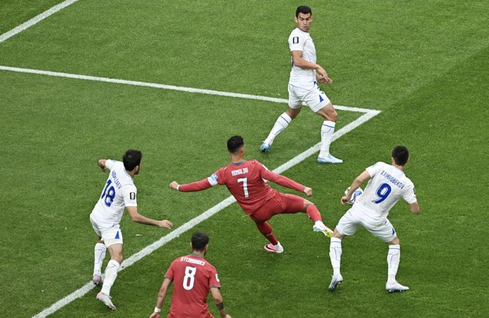  Trong vòng vây của 5 cầu thủ Uzbekistan, Ronaldo vẫn tìm ra cách để dứt điểm thành bàn. Ảnh: Reuters. 