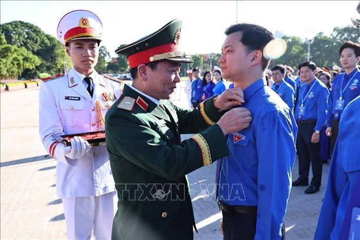 Trao huy hiệu Bác Hồ cho các đại biểu.