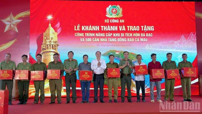 Đại diện lãnh đạo Bộ Công an và tỉnh Cà Mau trao tặng quà cho người dân địa phương nhân sự kiện.