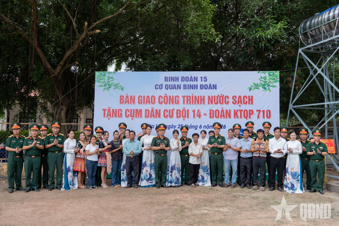  Bộ đội và bà con Cụm dân cư số 2 bên công trình nước sạch.