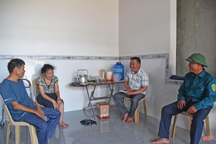 Cán bộ xã và thôn xóm đến động viên các hộ nghèo, hộ cận nghèo được hỗ trợ làm nhà ở.
