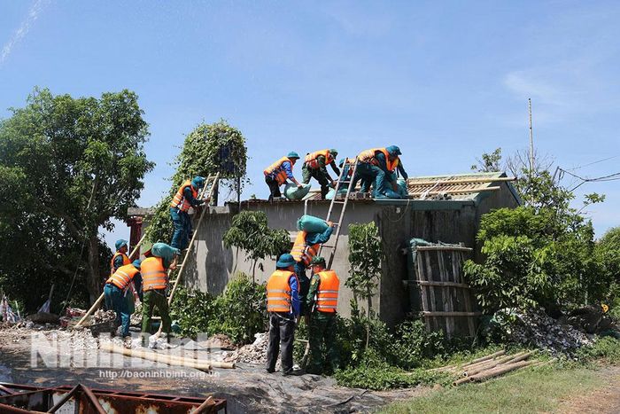 Diễn tập chằng chống nhà của người tại khu vực nuôi thủy sản phía ngoài đê, giúp giảm thiểu thiệt hại tài sản cho người dân. Ảnh: Mạnh Hùng