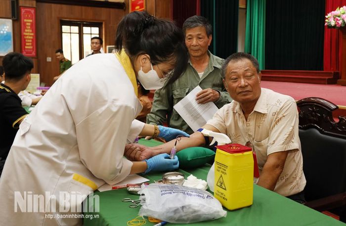 Cán bộ kỹ thuật thực hiện thu nhận mẫu sinh phẩm ADN cho thân nhân liệt sĩ theo quy định.