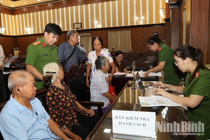 Thân nhân liệt sĩ được cán bộ Công an hỗ trợ kê khai, đối chiếu thông tin trước khi thu nhận mẫu ADN.