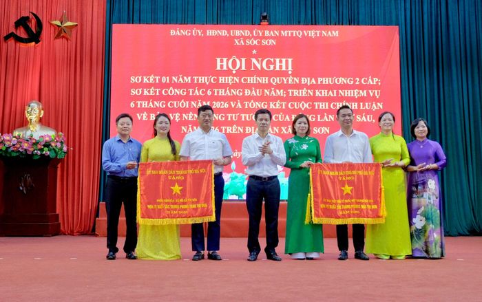 Phó Chủ tịch UBND thành phố Hà Nội Bùi Duy Cường trao Cờ thi đua tặng các tập thể, cá nhân của xã Sóc Sơn. Ảnh: Tùng Nguyễn