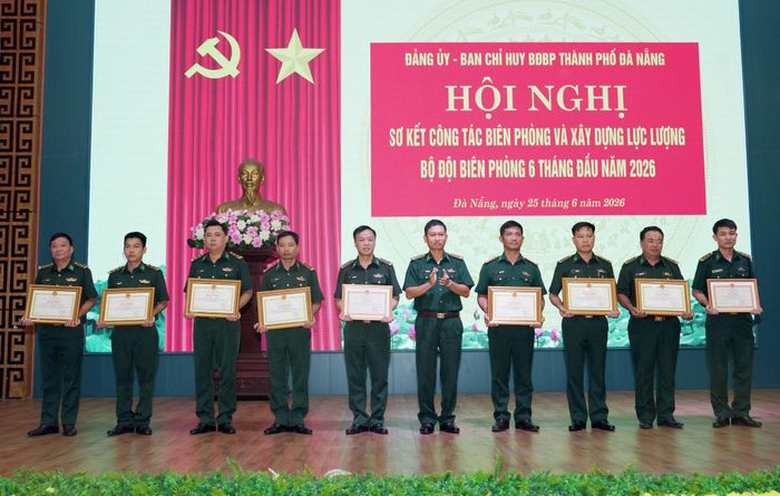 Đại tá Trần Tiến Hiền trao bằng khen cho các tập thể, cá nhân đạt thành tích xuất sắc trong công tác biên phòng. Ảnh: HỒNG ANH